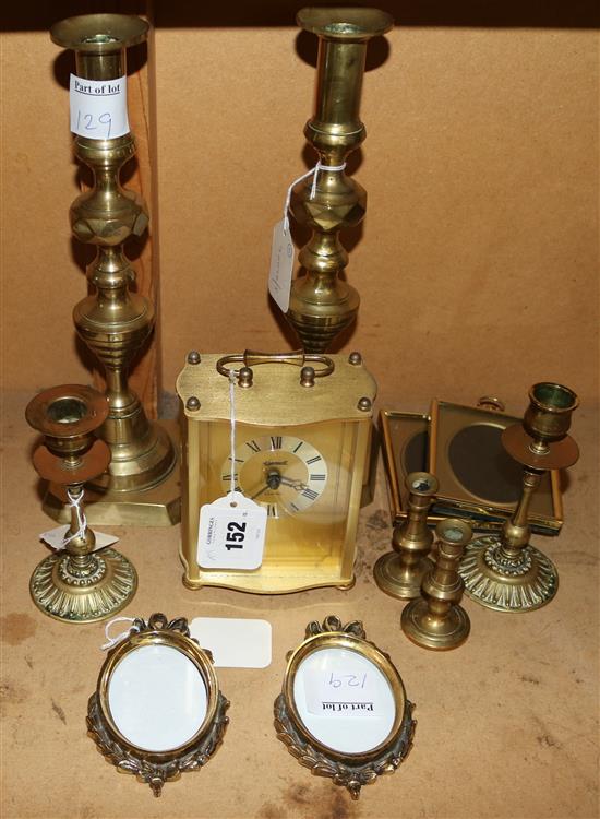 Pair of brass candlesticks, two pairs brass taper sticks, two pairs of brass miniature frames & an Ingersoll quartz clock